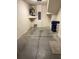 One-car garage with storage shelves and utility sink at 5467 Soapstone Pl # 203, Sarasota, FL 34233