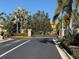 Gated community entrance with security gate and lush landscaping at 5467 Soapstone Pl # 203, Sarasota, FL 34233