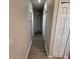 Hallway with wood-look flooring and multiple doors leading to other rooms at 5467 Soapstone Pl # 203, Sarasota, FL 34233