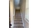 Carpeted stairs leading to the second floor at 5467 Soapstone Pl # 203, Sarasota, FL 34233
