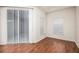 Bedroom with hardwood floors, sliding glass doors, and window blinds at 566 Oak Bay Dr, Osprey, FL 34229