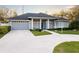 House exterior showcasing a two-car garage and manicured lawn at 566 Oak Bay Dr, Osprey, FL 34229