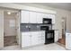 White kitchen with black appliances and gray countertops at 566 Oak Bay Dr, Osprey, FL 34229