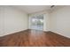Bright living room with hardwood floors and sliding glass doors at 566 Oak Bay Dr, Osprey, FL 34229