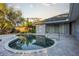 Inviting kidney shaped pool with patio and house view at 566 Oak Bay Dr, Osprey, FL 34229