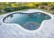 Irregular shaped pool with tiled coping and patio at 566 Oak Bay Dr, Osprey, FL 34229