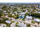 Wide aerial view of a coastal neighborhood with a blue house near the water at 7007 Holmes Blvd, Holmes Beach, FL 34217