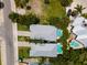 Two homes with gray roofs and private pools, viewed from above at 7007 Holmes Blvd, Holmes Beach, FL 34217