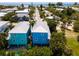 Two blue houses near the beach, seen from above at 7007 Holmes Blvd, Holmes Beach, FL 34217