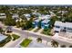 Aerial view showing a blue home's location, neighboring houses, and a waterfront at 7007 Holmes Blvd, Holmes Beach, FL 34217