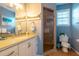 Bathroom with walk-in shower and single vanity at 7007 Holmes Blvd, Holmes Beach, FL 34217