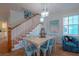 Charming dining area with a farmhouse table and blue chairs at 7007 Holmes Blvd, Holmes Beach, FL 34217