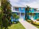 Two story home with blue exterior and paved driveway at 7007 Holmes Blvd, Holmes Beach, FL 34217