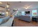 Open living space with kitchen island, staircase, and comfortable seating at 7007 Holmes Blvd, Holmes Beach, FL 34217