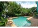 Inviting pool with lounge chairs and lush landscaping at 7007 Holmes Blvd, Holmes Beach, FL 34217