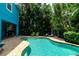 Relaxing pool area with patio furniture and lush landscaping at 7007 Holmes Blvd, Holmes Beach, FL 34217