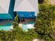 Aerial view of a freeform turquoise pool and patio with lounge chairs at 7007 Holmes Blvd, Holmes Beach, FL 34217