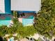 Aerial view of a freeform pool and surrounding patio area at 7007 Holmes Blvd, Holmes Beach, FL 34217