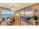 Dining room with sunset view over the ocean and access to balcony at 775 Longboat Club Rd # 708, Longboat Key, FL 34228