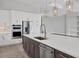 Modern kitchen with island, stainless steel appliances, and white cabinets at 8372 Sea Glass Ct, Sarasota, FL 34240