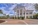 Grand entrance to the community with a porte cochere and manicured landscaping at 855 Macewen Dr, Osprey, FL 34229