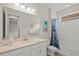 Bathroom with single vanity, shower/tub combo, and decorative shower curtain at 8792 Rain Song Rd, Sarasota, FL 34238