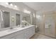 Double vanity bathroom with a walk-in shower and modern fixtures at 8792 Rain Song Rd, Sarasota, FL 34238