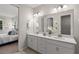Double vanity bathroom with a large mirror and modern fixtures at 8792 Rain Song Rd, Sarasota, FL 34238