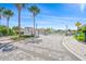 Gated community entrance with palm trees and landscaping at 8792 Rain Song Rd, Sarasota, FL 34238