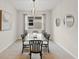 Bright dining room features a glass table and modern chairs, perfect for Gathering meals at 8792 Rain Song Rd, Sarasota, FL 34238