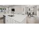 Modern kitchen with white cabinets, quartz countertops, and island at 8792 Rain Song Rd, Sarasota, FL 34238