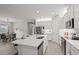 Modern kitchen with white cabinets, quartz countertops, and island at 8792 Rain Song Rd, Sarasota, FL 34238