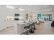 Modern kitchen with white cabinets, quartz countertops, and stainless steel appliances at 8792 Rain Song Rd, Sarasota, FL 34238