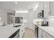 Modern kitchen with white cabinets, quartz countertops, and island at 8792 Rain Song Rd, Sarasota, FL 34238