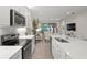 Modern kitchen with white cabinets, quartz countertops, and island at 8792 Rain Song Rd, Sarasota, FL 34238