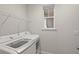 Bright laundry room with washer, dryer, and shelving at 8792 Rain Song Rd, Sarasota, FL 34238