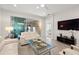 Living area with patio access and a flat-screen TV at 8792 Rain Song Rd, Sarasota, FL 34238