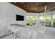Outdoor kitchen with bar seating and flat screen TV at 8792 Rain Song Rd, Sarasota, FL 34238