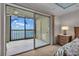 A view of the balcony overlooking a tranquil body of water, accessed through sliding glass doors at 9393 Midnight Pass Rd # 201, Sarasota, FL 34242