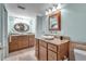 Spacious bathroom with dual sinks, granite counters, and a large mirror at 9393 Midnight Pass Rd # 201, Sarasota, FL 34242