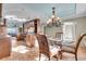 Open concept dining area with a chandelier, tile floors, and great natural light at 9393 Midnight Pass Rd # 201, Sarasota, FL 34242