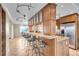 Open concept kitchen with breakfast bar seating, granite countertops, and stylish track lighting at 9393 Midnight Pass Rd # 201, Sarasota, FL 34242