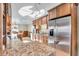 Modern kitchen with granite counters, stainless steel refrigerator, and breakfast bar at 9393 Midnight Pass Rd # 201, Sarasota, FL 34242