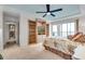 Spacious main bedroom with built-in shelving, ceiling fan, and sliding glass door access to balcony at 9393 Midnight Pass Rd # 201, Sarasota, FL 34242