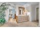 Inviting main bedroom with dresser, mirror, and access to walk-in closet and main bathroom at 9393 Midnight Pass Rd # 201, Sarasota, FL 34242