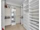 Organized walk-in closet with shelving and mirrors and access to main bedroom at 9393 Midnight Pass Rd # 201, Sarasota, FL 34242