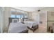Guest bedroom with two twin beds and ample closet space at 1055 Gulf Of Mexico Dr # 504, Longboat Key, FL 34228