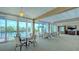 Community room with ocean views, tables, and chairs at 1055 Gulf Of Mexico Dr # 504, Longboat Key, FL 34228