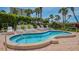 Relax in this community hot tub, featuring a curved design and multiple lounge chairs at 1055 Gulf Of Mexico Dr # 504, Longboat Key, FL 34228