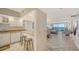 Open kitchen with white cabinets and granite countertops at 1055 Gulf Of Mexico Dr # 504, Longboat Key, FL 34228